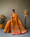 Orange color leheriya silk saree with golden zari woven work