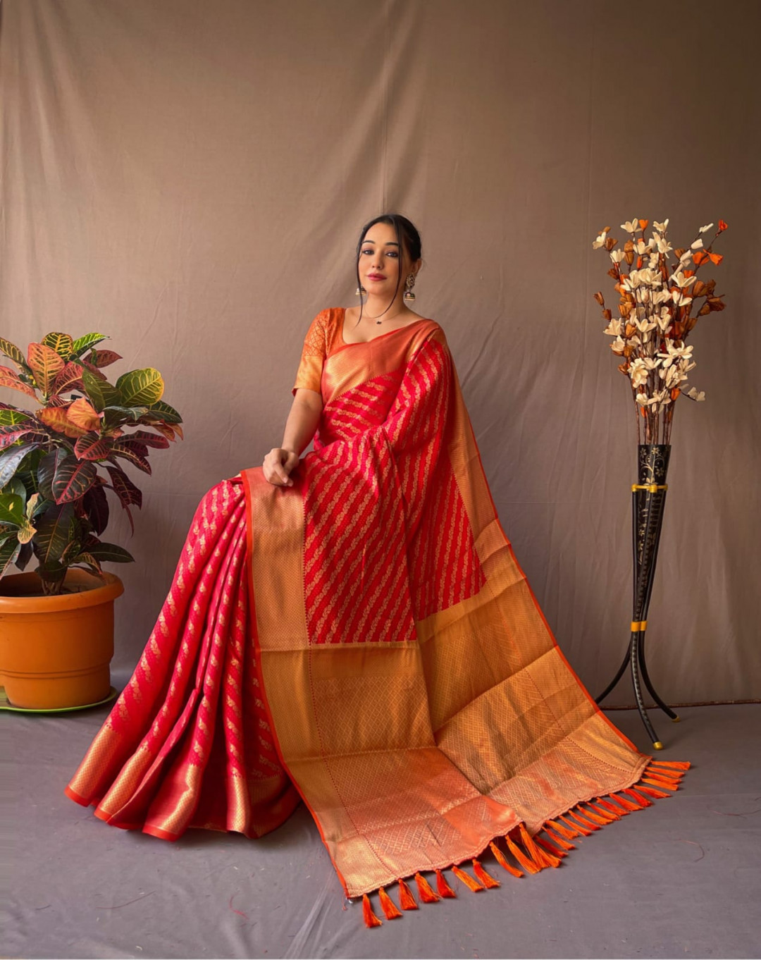 Red color leheriya silk saree with golden zari woven work
