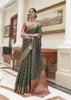 Bottle green color patola silk saree with woven design