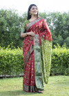 Red and mahendi green color bandhej silk saree with printed work