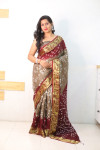 Beige and maroon color bandhej silk saree with zari weaving work