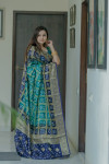 Green and navy blue color bandhej silk saree with zari weaving work