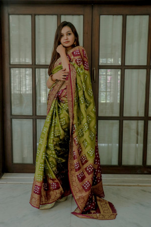 Mahendi green and magenta color bandhej silk saree with zari weaving work