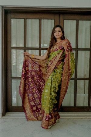 Mahendi green and magenta color bandhej silk saree with zari weaving work