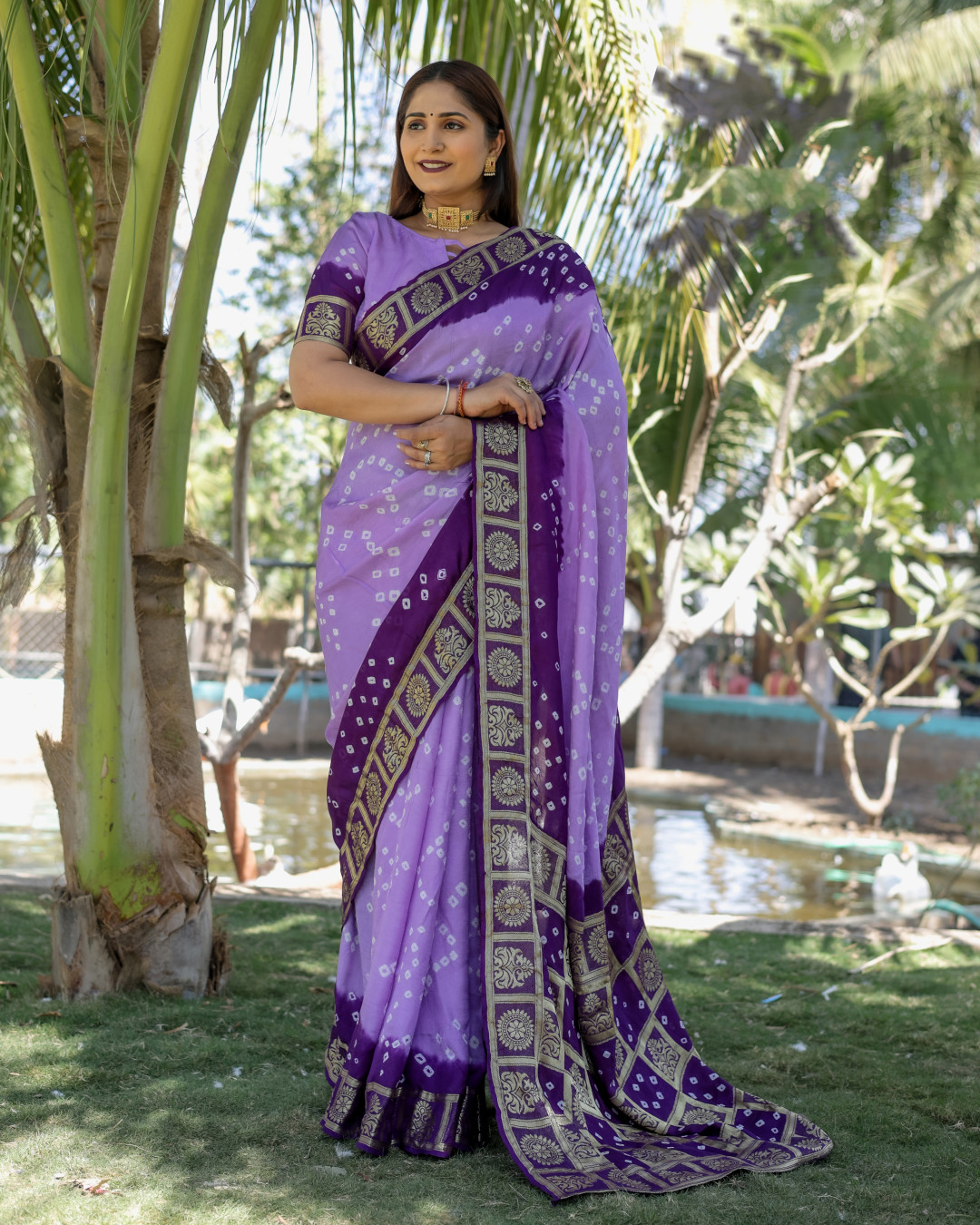 Purple color hand bandhej silk saree with zari weaving work