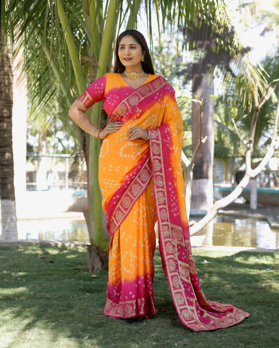Orange and pink color bandhej silk saree with zari weaving work