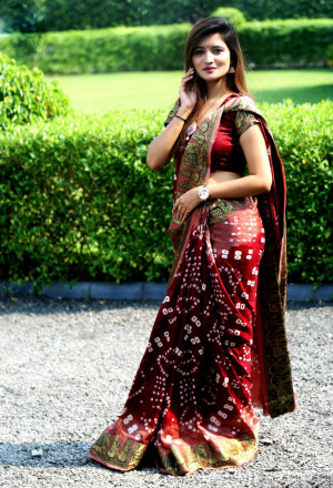 Maroon color hand bandhej bandhani saree with zari weaving border
