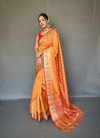 Orange color banarasi silk saree with zari weaving work