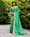 Green color patola silk saree with woven design