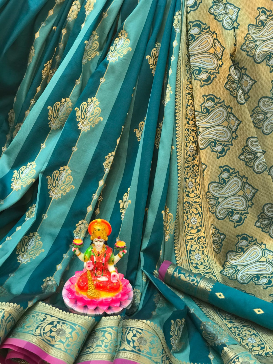 Rama green color soft banarasi silk saree with zari woven border