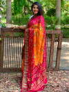 Yellow and rani pink color pure hand bandhej silk saree with zari weaving work