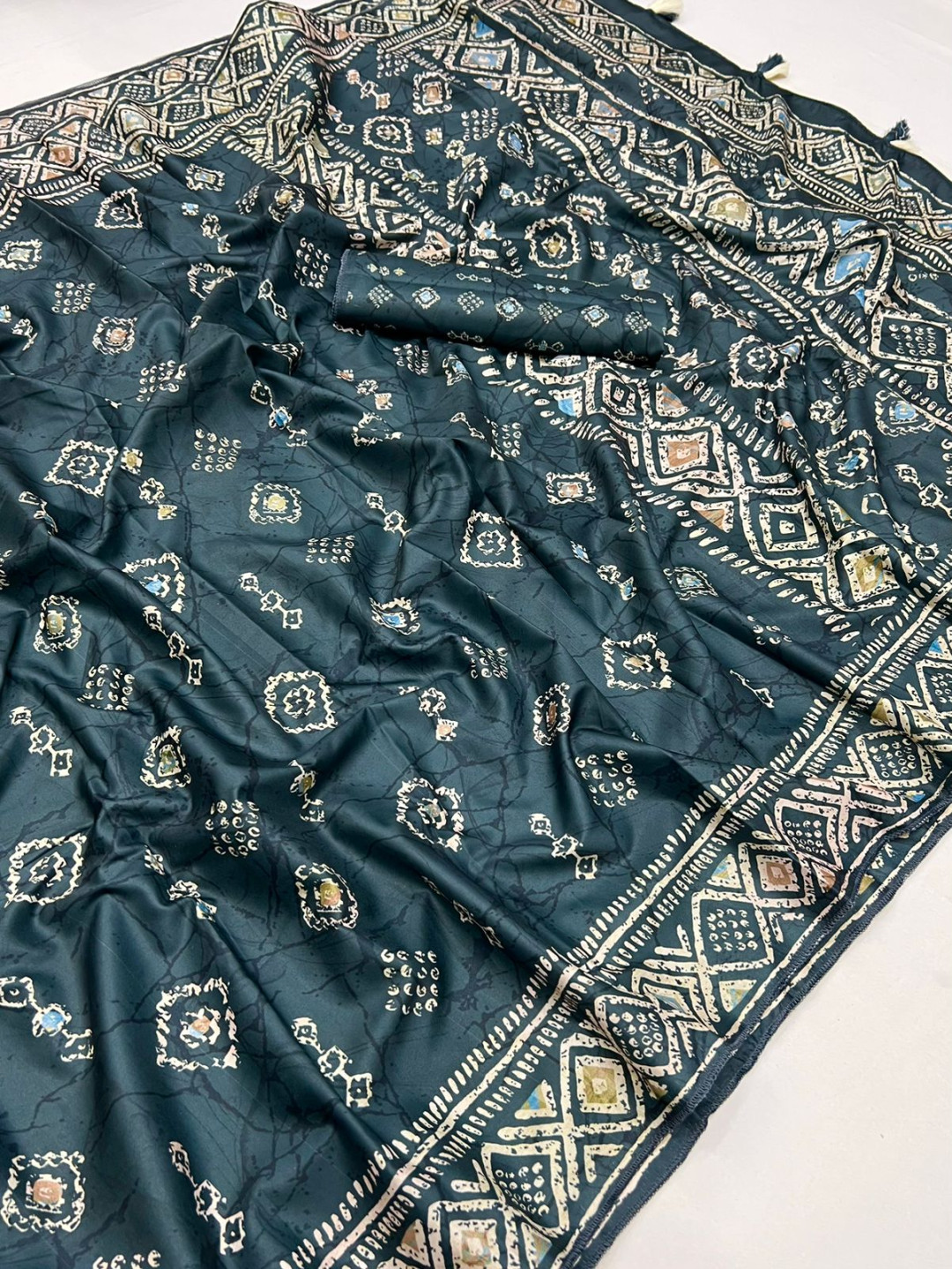 Dark green color dola silk saree with batik printed work