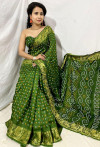 Mehandi green color bandhani silk saree with khadi printed work