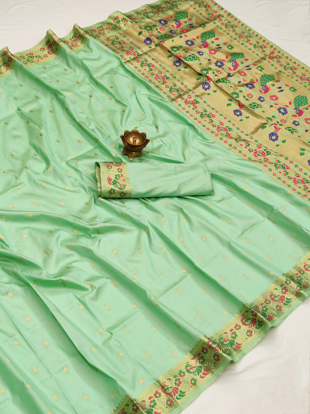 Pista green color paithani silk saree with zari weaving work
