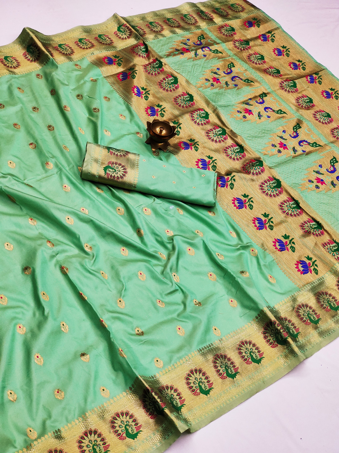 Sea green color paithani silk saree with zari weaving work