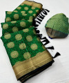 Green color kora muslin silk saree with woven design