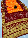 Maroon and orangr color bandhej silk saree with zari weaving work