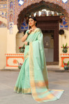 Pista green color tussar silk saree with zari woven border